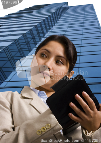 Image of A Businesswoman Writing in a Personal Organizer