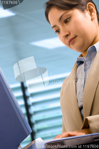 Image of A Businesswoman At Her Desk Using A Notebook Computer