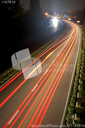 Image of road with car traffic at night with blurry lights