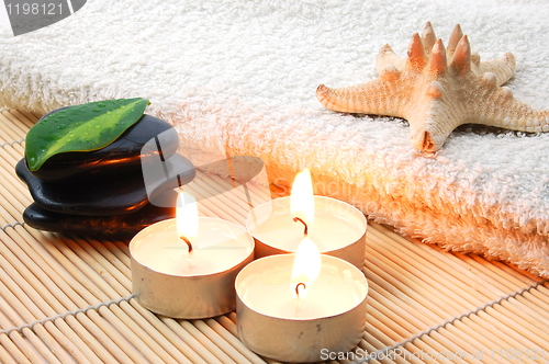 Image of foldet white bath towel and zen stones