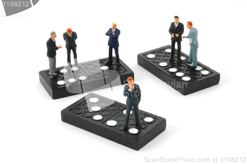 Image of business man on domino isolated