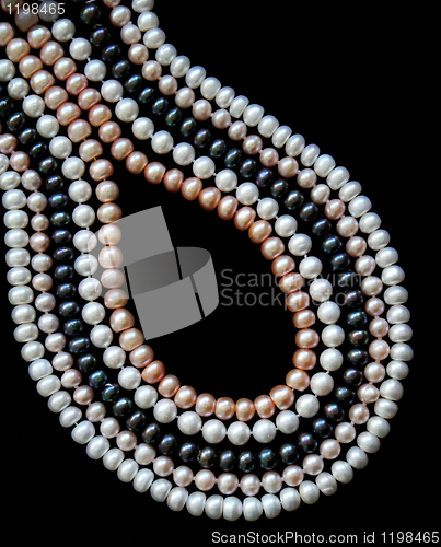 Image of White, black and pink pearls on the black silk