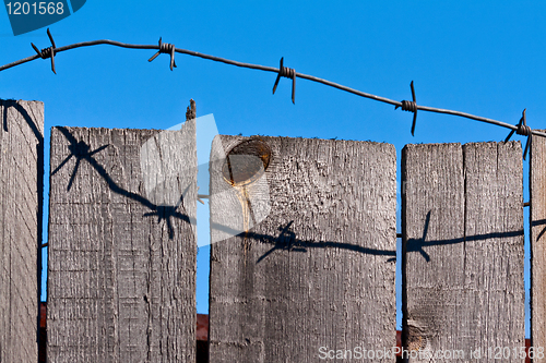 Image of wooden fence of barbed wire