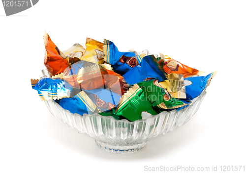 Image of glass vase with candy in colorful wrappers