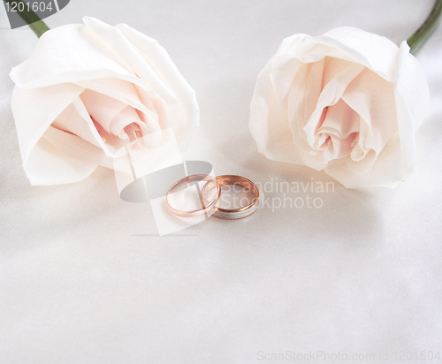 Image of Wedding rings and roses as background 