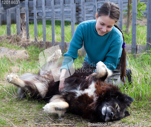 Image of Girl playing with dog