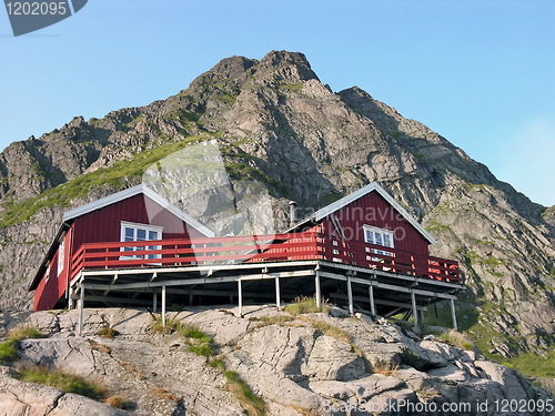 Image of Two wooden red cottage on the mountain