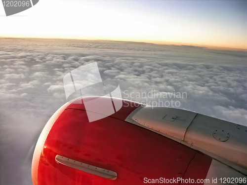 Image of Airplane engine in sunset sky
