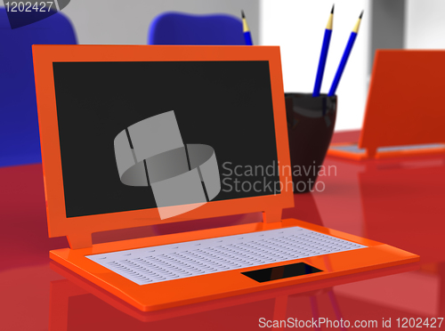 Image of Laptop on red table with blue pencils