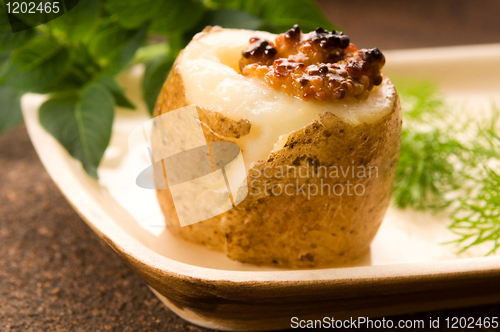 Image of Baked potato with sour cream, grain Dijon mustard and herbs