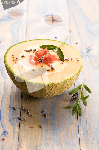 Image of fresh melon soup with parma ham and lavender flower