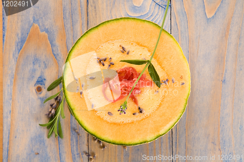 Image of fresh melon soup with parma ham and lavender flower