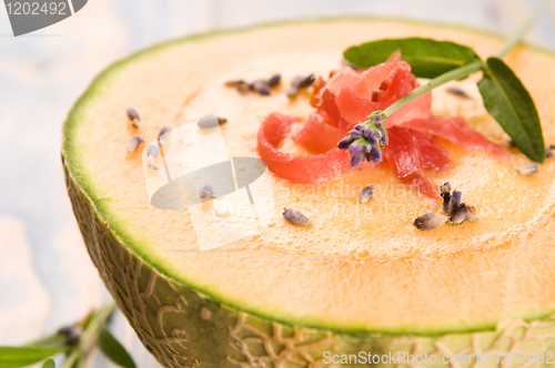 Image of fresh melon soup with parma ham and lavender flower