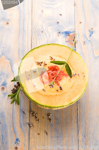 Image of fresh melon soup with parma ham and lavender flower