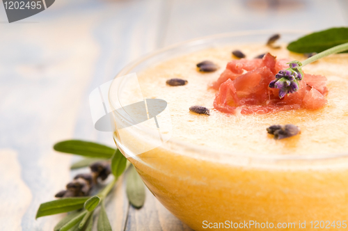 Image of fresh melon soup with parma ham and lavender flower