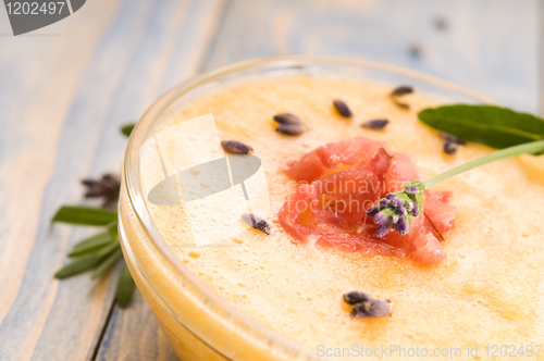 Image of fresh melon soup with parma ham and lavender flower