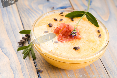 Image of fresh melon soup with parma ham and lavender flower