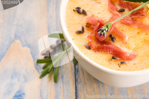 Image of fresh melon soup with parma ham and lavender flower