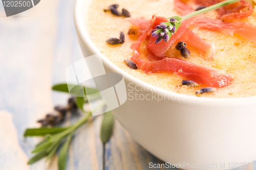 Image of fresh melon soup with parma ham and lavender flower