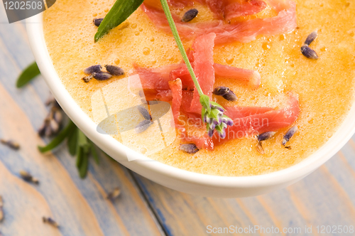 Image of fresh melon soup with parma ham and lavender flower