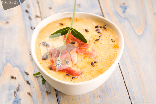 Image of fresh melon soup with parma ham and lavender flower