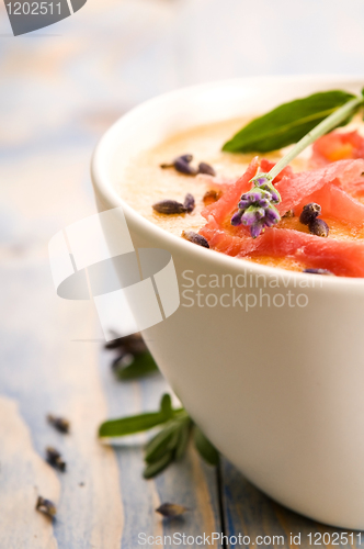 Image of fresh melon soup with parma ham and lavender flower