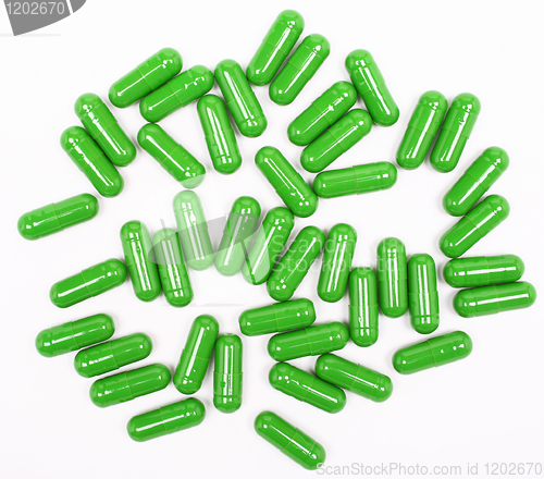 Image of Green pills on white background 