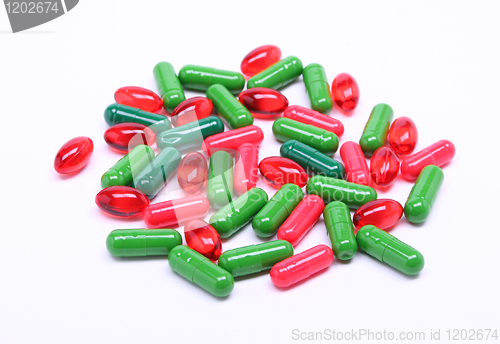 Image of Red and green pills on white background 