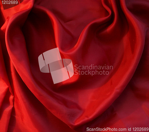 Image of Red heart from elegant red silk as background