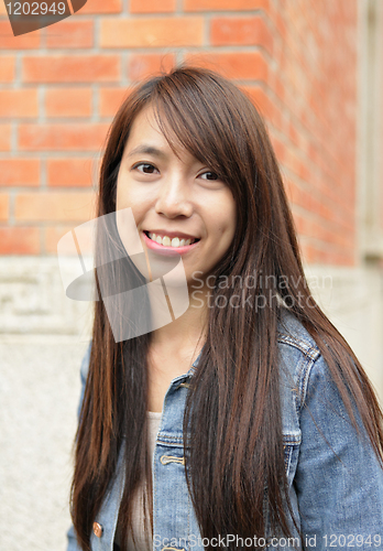 Image of young woman smiling friendly