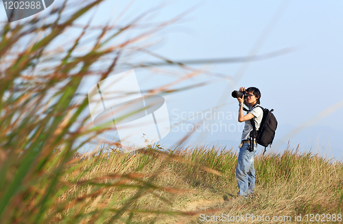 Image of Photographer taking photo outdoor