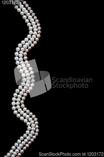 Image of White and pink pearls on the black silk 