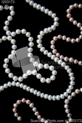 Image of White and pink pearls on the black silk 