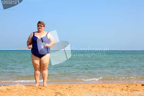 Image of overweight woman on beach