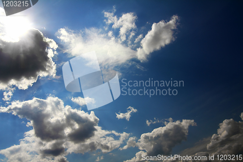 Image of clouds and sun on blue sky