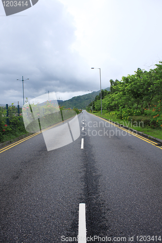 Image of Long road stretching out into the distance under a dramatic blue