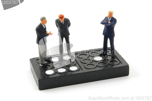 Image of business man on domino isolated