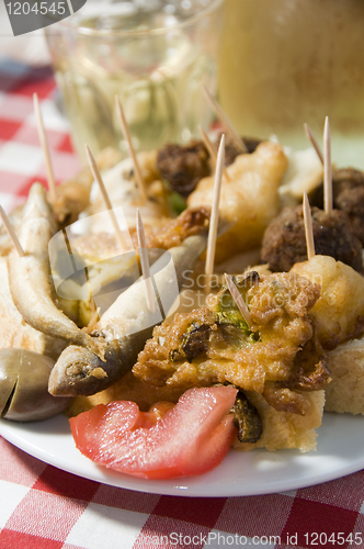 Image of plate of mezes appetizers wine Greek food