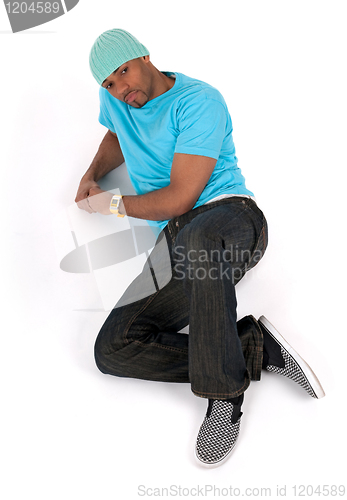 Image of Young man in a blue t-shirt lying down thinking