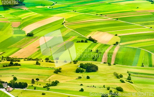 Image of aerial view of green fields and slopes