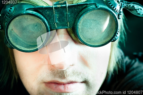 Image of Young survivor of the apocalypse in goggles with light