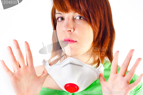Image of Beautiful young girl holding protective mask