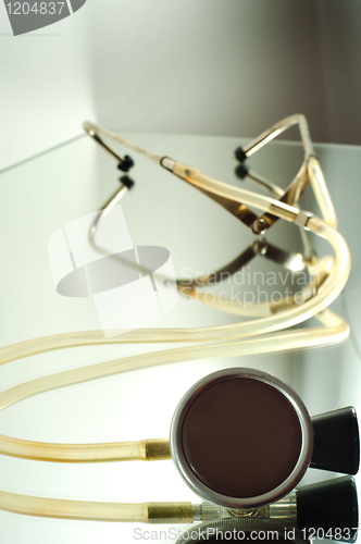 Image of stethoscope on a glass shelf with copyspace