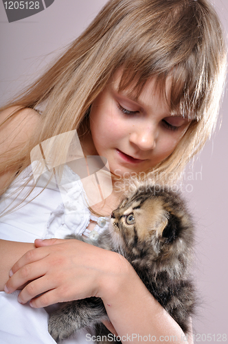 Image of child cuddling  a kitten