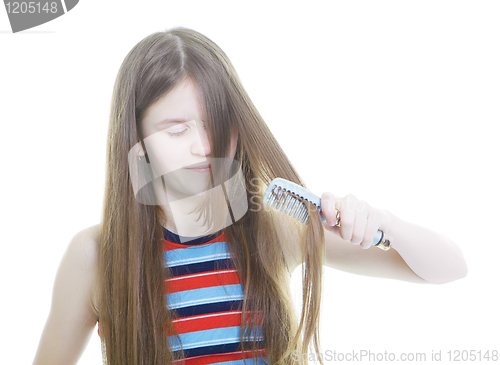 Image of Teen girl combing her long hair