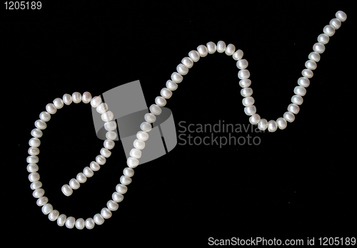 Image of White pearls on the black silk