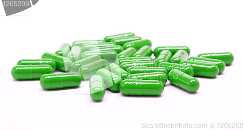 Image of Green pills on white background 