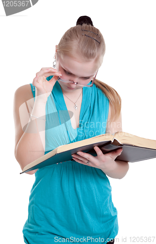 Image of A young girl in glasses with a book