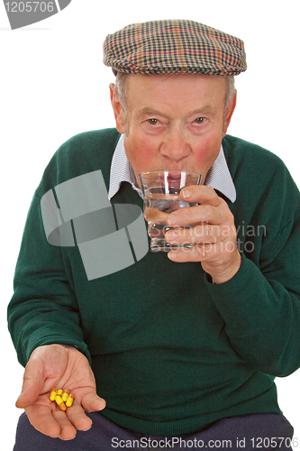 Image of Male senior taking medicine