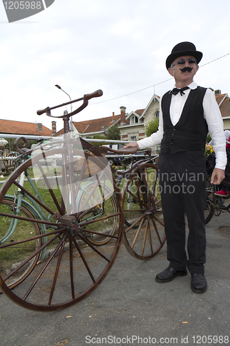 Image of Biker with an old bicycle.